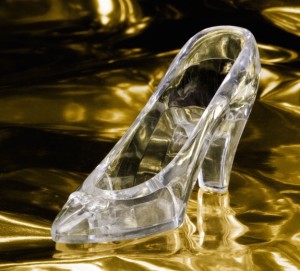 Cinderella's magical glass slipper floating on a golden sea.