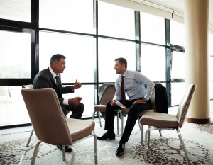 Coworkers discussing project in conference room